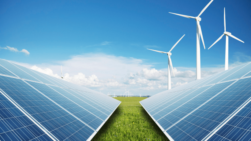 Solar panels and wind turbines on a field.