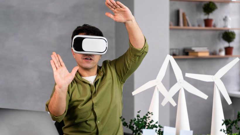 Man in VR headset interacting with wind turbines.