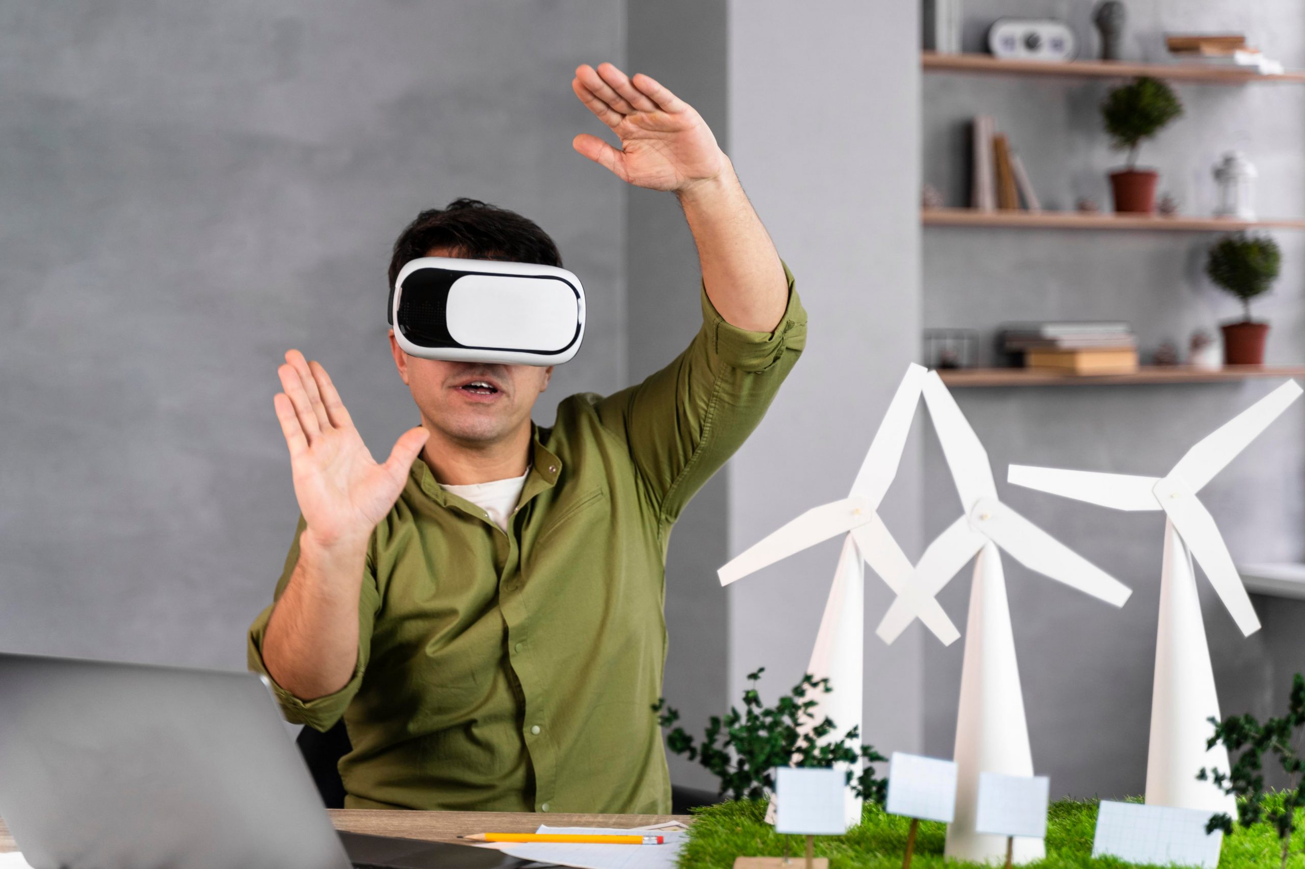 Man in VR headset interacting with wind turbines.