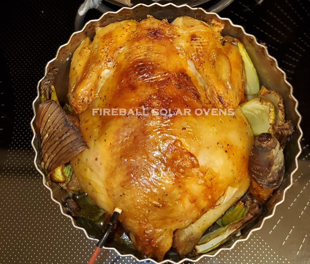 Roasted chicken with vegetables in a pan.