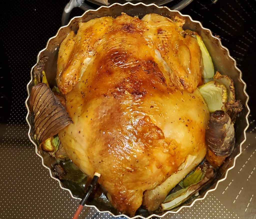 Roasted chicken with vegetables in a pan.