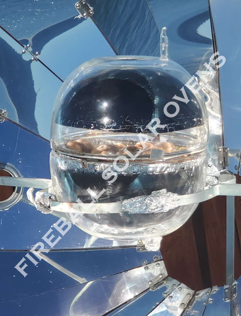 Solar oven cooking food in a glass bowl.